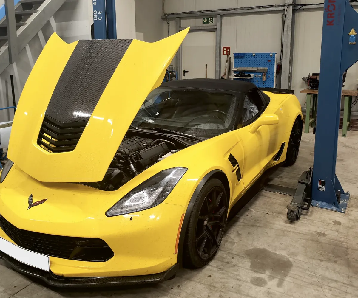 Gelber Sportwagen mit geöffneter Motorhaube
